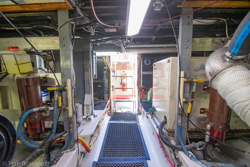 Slide: The Image of Engine room of a 1987 Hatteras 52 Convertible yacht, showcasing mechanical components. - 65