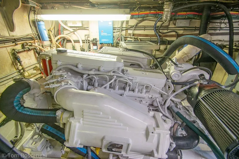 Slide: The Image of Engine room of a 1987 Hatteras 52 Convertible yacht, showcasing detailed machinery. - 63