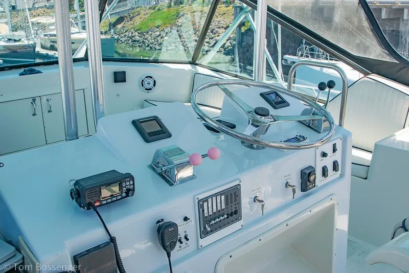 Slide: The Image of Cockpit of 1987 Hatteras 52 Convertible yacht with steering wheel and control panel. - 44