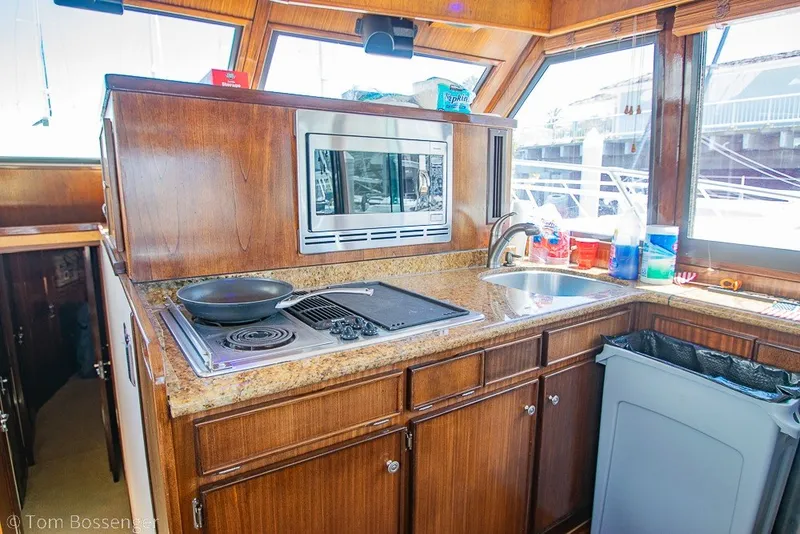 Slide: The Image of 1987 Hatteras 52 Convertible yacht kitchen with stove, microwave, and sink. - 15