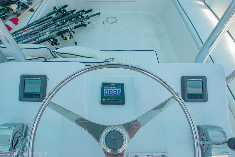 Slide: The Image of Helm of 1987 Hatteras 52 Convertible with fishing rods and navigation instruments. - 47
