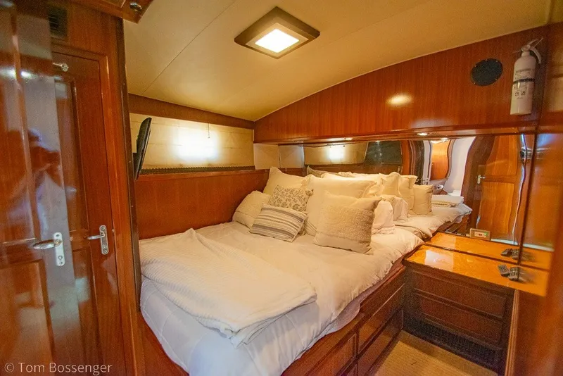 Slide: The Image of Luxurious cabin interior of 1987 Hatteras 52 Convertible yacht with cozy bedding. - 23
