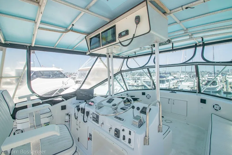 Slide: The Image of Cockpit of 1987 Hatteras 52 Convertible yacht with marina view. - 43
