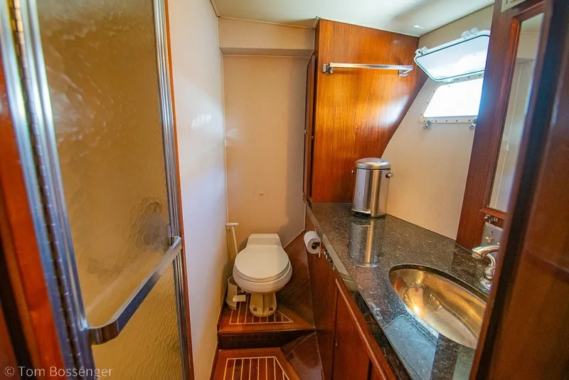 Slide: The Image of Bathroom interior of 1987 Hatteras 52 Convertible yacht with wooden cabinetry and granite countertop. - 27