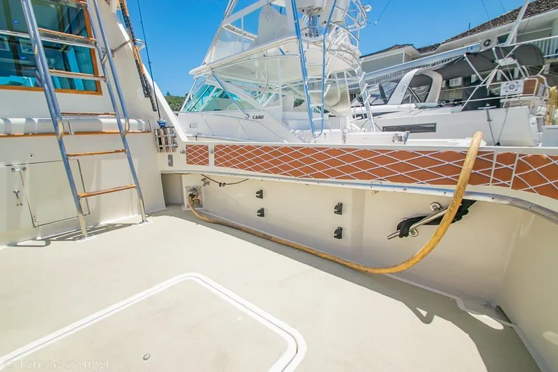 Slide: The Image of 1987 Hatteras 52 Convertible yacht deck with ladder and fishing equipment. - 40