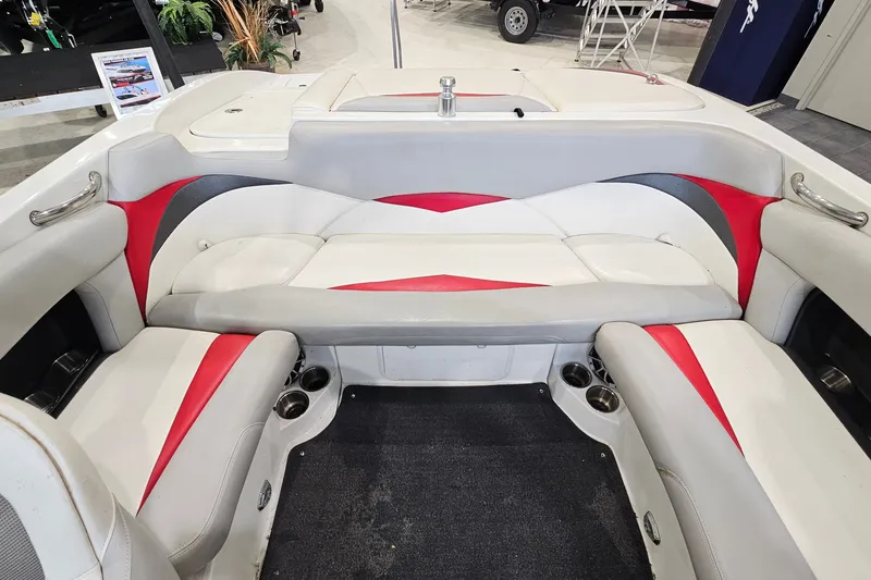 Slide: The Image of Interior of a 2010 Tigé 22Ve boat with red and white seating. - 10