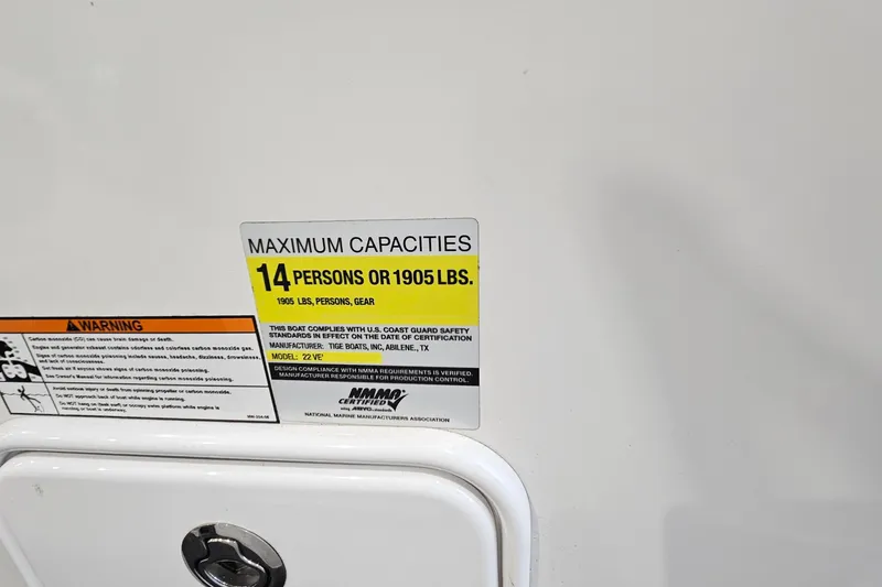 Slide: The Image of Capacity label on 2010 Tigé 22Ve boat, maximum 14 persons or 1905 lbs. - 18
