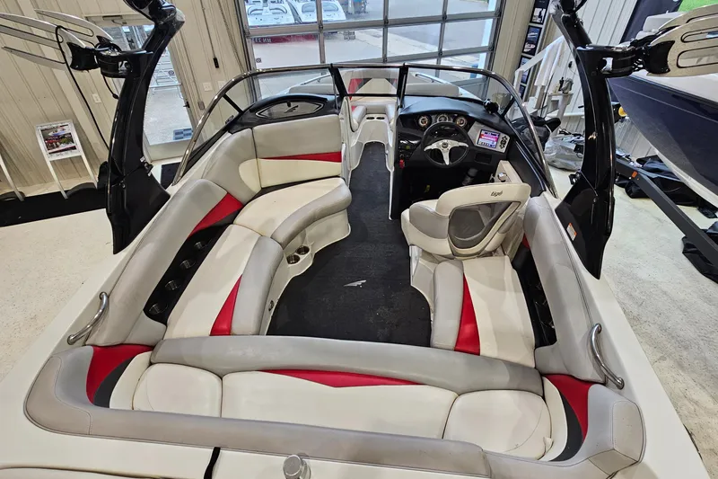Slide: The Image of Interior of a 2010 Tigé 22Ve boat with red and white seating. - 8