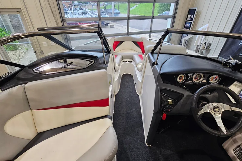 Slide: The Image of Interior of a 2010 Tigé 22Ve boat with modern dashboard and seating. - 14