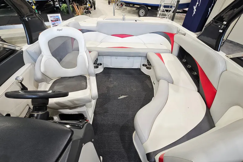Slide: The Image of Interior of a 2010 Tigé 22Ve boat with white and red seating. - 9