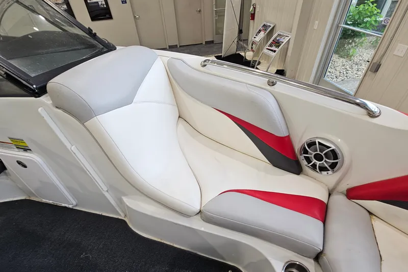 Slide: The Image of 2010 Tigé 22Ve boat interior with white, gray, and red seating and speaker detail. - 17