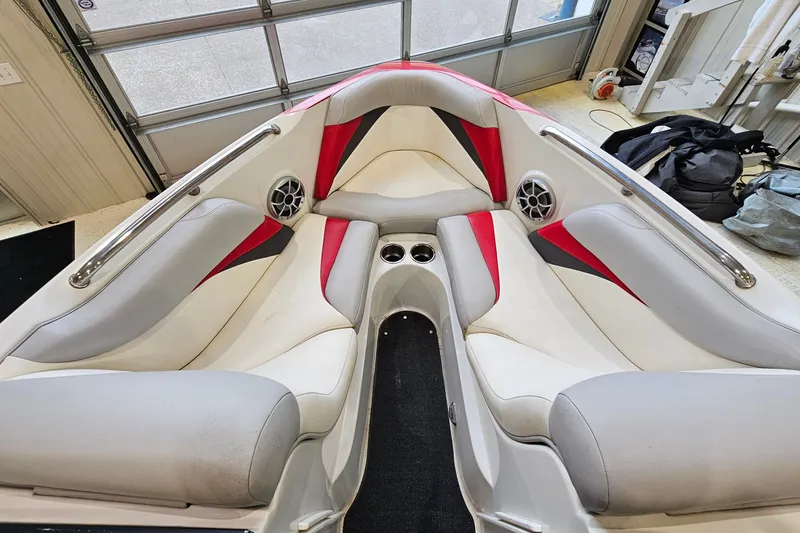 Slide: The Image of Interior of 2010 Tigé 22Ve boat with red and gray seating. - 15