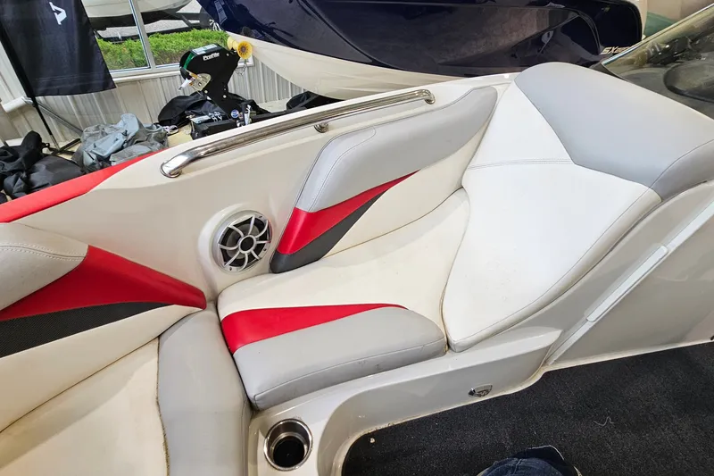 Slide: The Image of Interior of a 2010 Tigé 22Ve boat with red and white seating. - 16