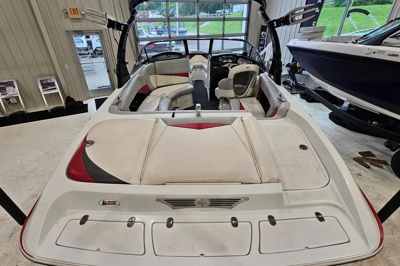 Slide: The Image of 2010 Tigé 22Ve boat interior with seating and dashboard in showroom setting. - 7
