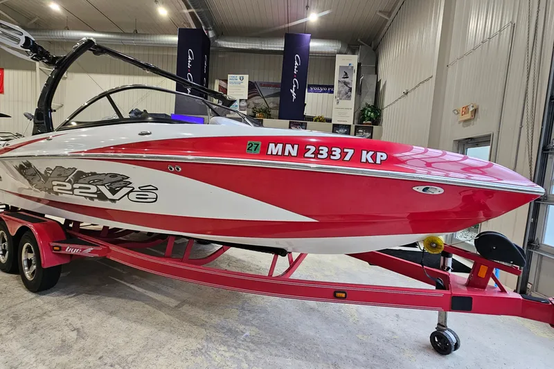 Slide: The Image of Red and white 2010 Tigé 22Ve boat on trailer in indoor showroom. - 4