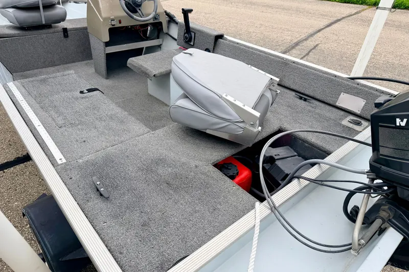 Slide: The Image of 1994 Tracker Guide V-14 Riveted Deep V boat interior with seating and controls. - 17