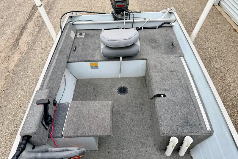 Slide: The Image of 1994 Tracker Guide V-14 Riveted Deep V boat interior with seating and storage compartments. - 30