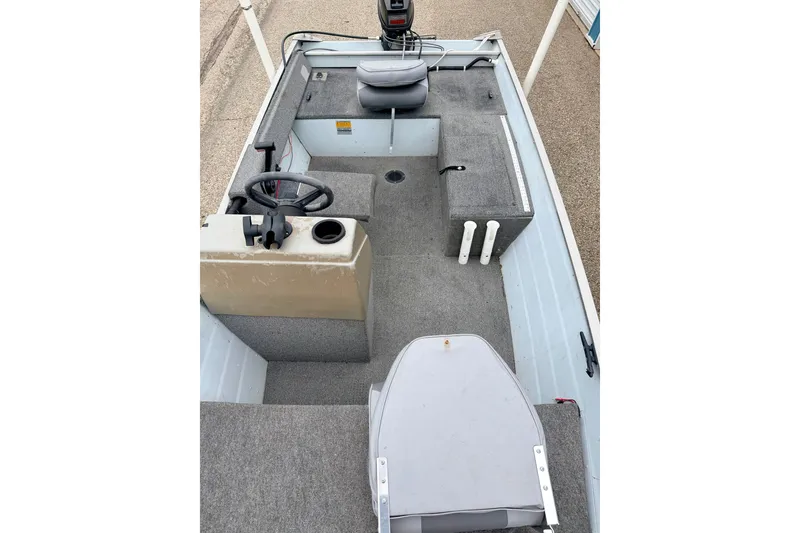 Slide: The Image of 1994 Tracker Guide V-14 Riveted Deep V boat interior with steering console and seating. - 33
