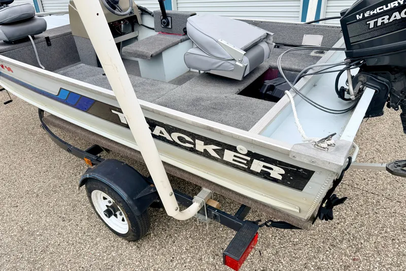 Slide: The Image of 1994 Tracker Guide V-14 Riveted Deep V boat on trailer, featuring Mercury outboard motor. - 41