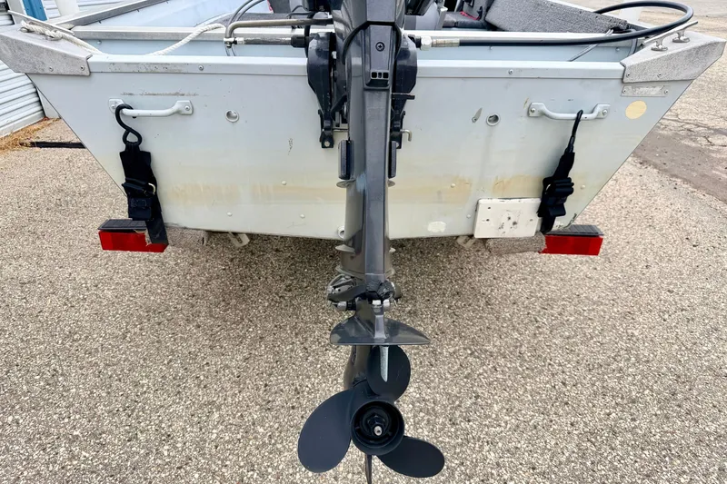 Slide: The Image of 1994 Tracker Guide V-14 Riveted Deep V boat with outboard motor, rear view. - 16