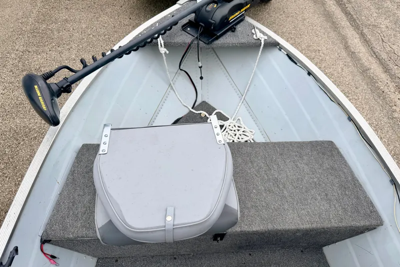 Slide: The Image of 1994 Tracker Guide V-14 Riveted Deep V boat interior with motor and seating. - 28