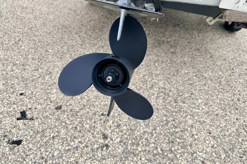 Slide: The Image of Propeller of a 1994 Tracker Guide V-14 Riveted Deep V boat on pavement. - 15