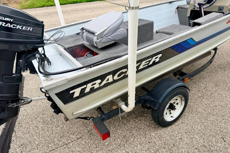 Slide: The Image of 1994 Tracker Guide V-14 Riveted Deep V boat on trailer, featuring Mercury outboard motor. - 42