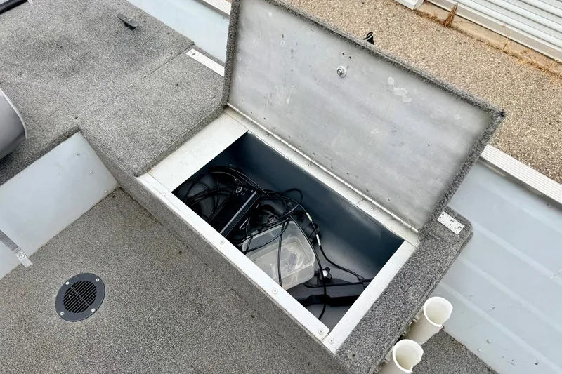 Slide: The Image of Open storage compartment on 1994 Tracker Guide V-14 Riveted Deep V boat. - 26