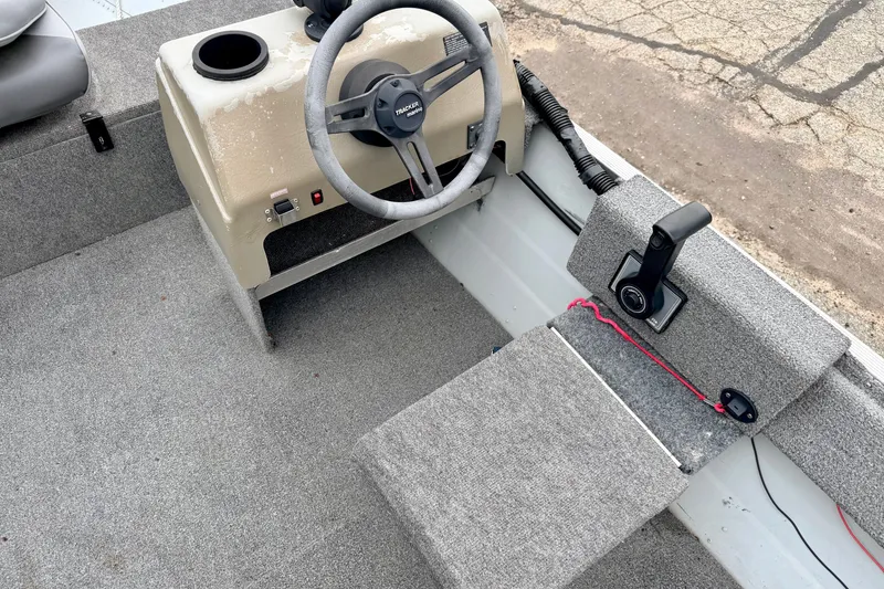 Slide: The Image of 1994 Tracker Guide V-14 boat interior with steering wheel and control panel. - 21