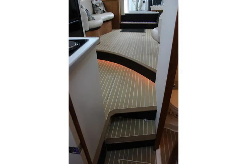 Slide: The Image of Interior of 1997 Silverton 351 Sedan yacht with modern wood flooring and seating area. - 59