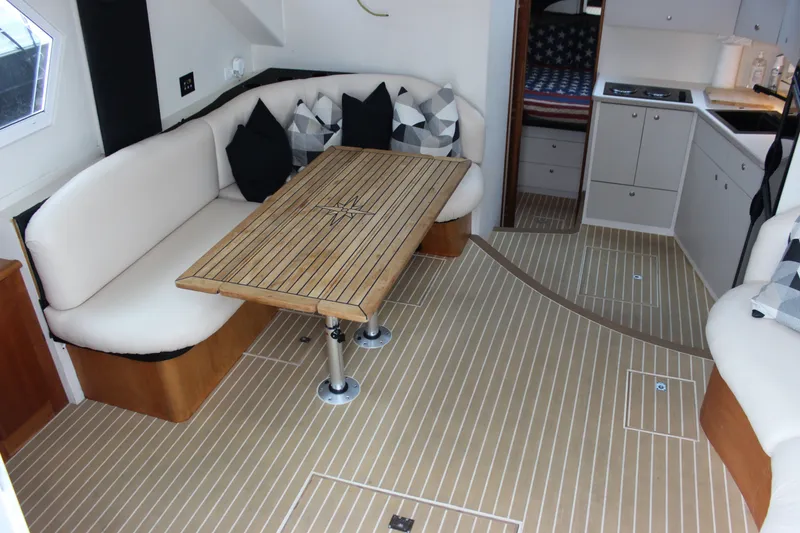 Slide: The Image of Interior of a 1997 Silverton 351 Sedan yacht with elegant seating and wooden table. - 25