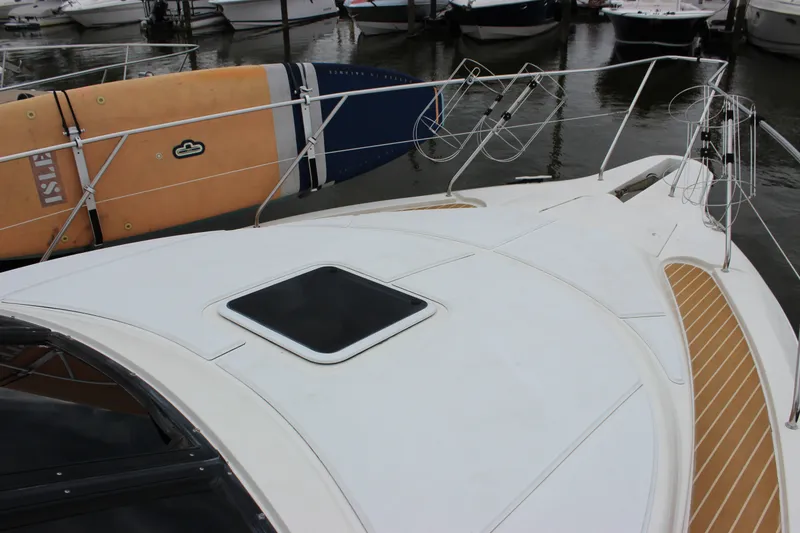 Slide: The Image of 1997 Silverton 351 Sedan yacht deck with paddleboard, docked in marina. - 43