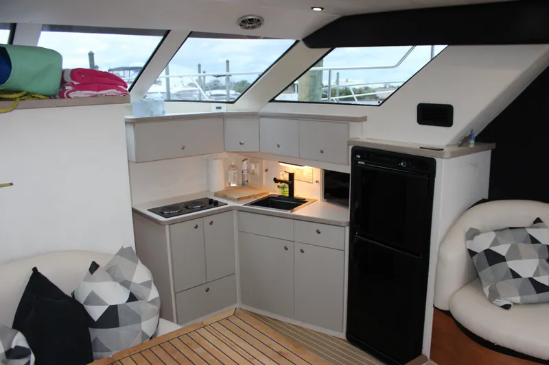 Slide: The Image of Interior of a 1997 Silverton 351 Sedan yacht with modern kitchen amenities. - 31