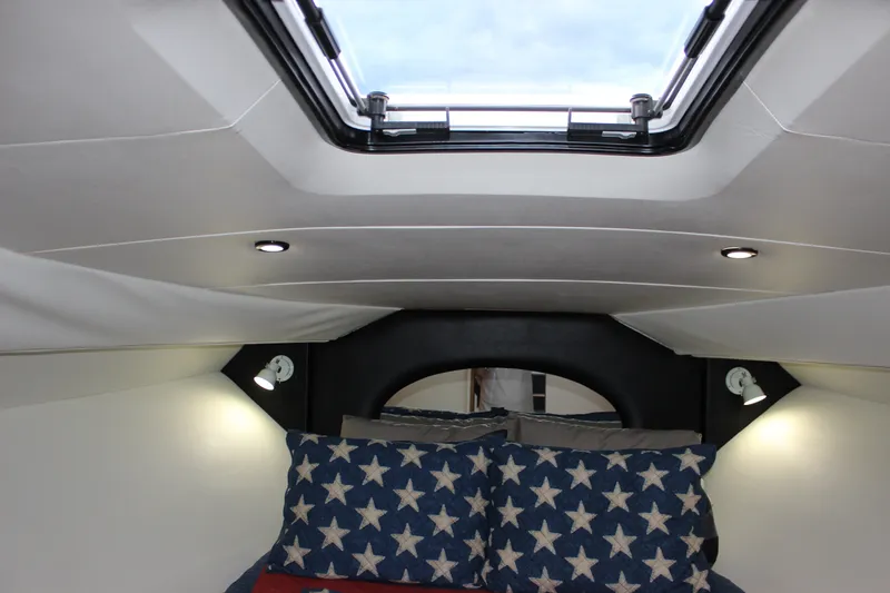 Slide: The Image of Interior cabin of 1997 Silverton 351 Sedan with star-patterned bedding and skylight. - 38