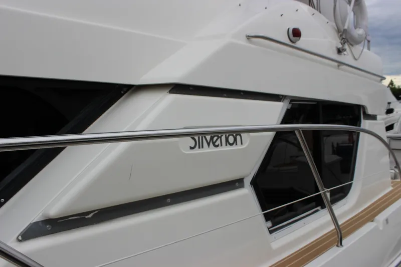 Slide: The Image of 1997 Silverton 351 Sedan yacht side view with railing and windows. - 79