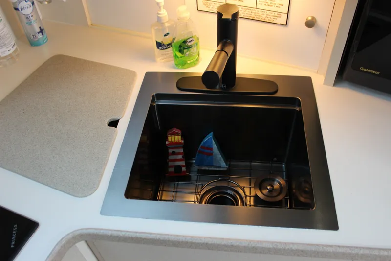 Slide: The Image of Kitchen sink with nautical decor on a 1997 Silverton 351 Sedan yacht. - 75