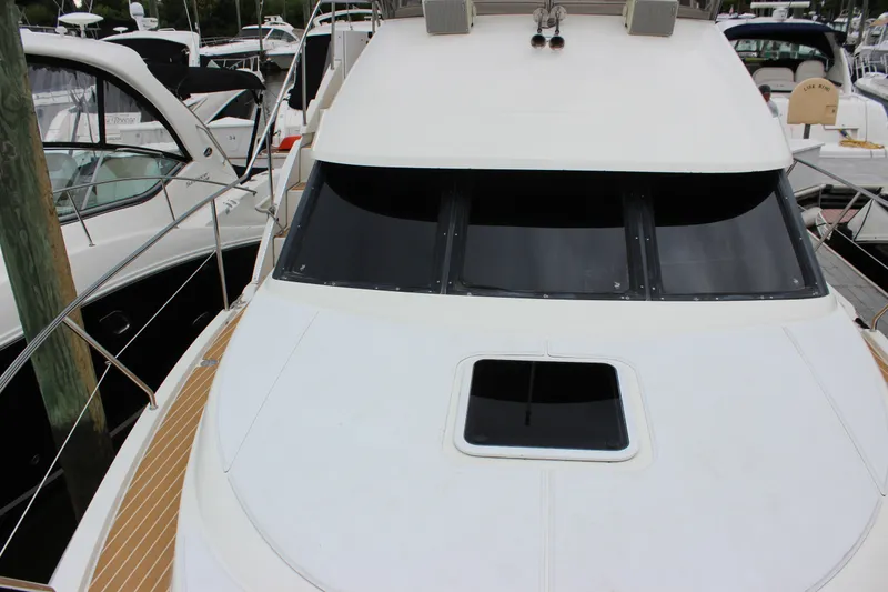 Slide: The Image of 1997 Silverton 351 Sedan yacht docked, showcasing sleek design and spacious deck area. - 48
