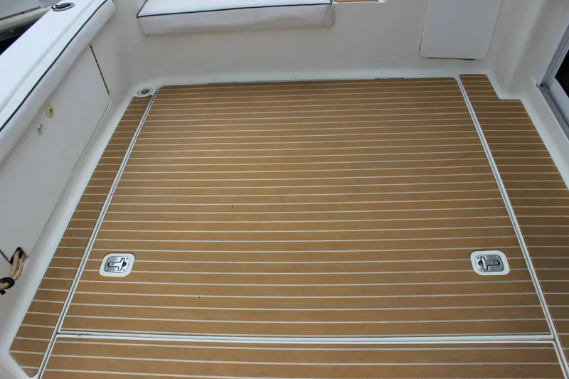 Slide: The Image of 1997 Silverton 351 Sedan boat deck with teak flooring and storage hatches. - 63