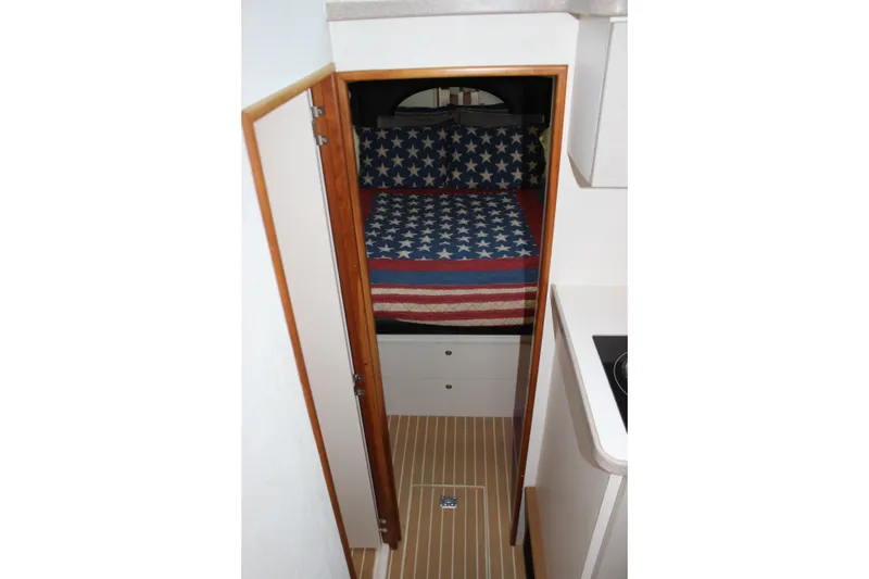 Slide: The Image of Interior of a 1997 Silverton 351 Sedan with American flag bedding. - 52
