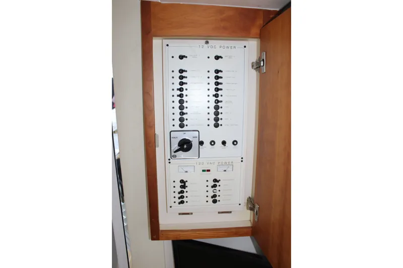 Slide: The Image of Electrical panel inside a 1997 Silverton 351 Sedan boat, featuring power controls and switches. - 61