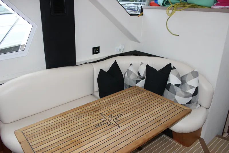 Slide: The Image of Luxurious interior of 1997 Silverton 351 Sedan with cushioned seating and decorative pillows. - 28