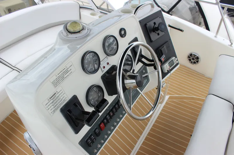 Slide: The Image of 1997 Silverton 351 Sedan helm with steering wheel, gauges, and control panel. - 21