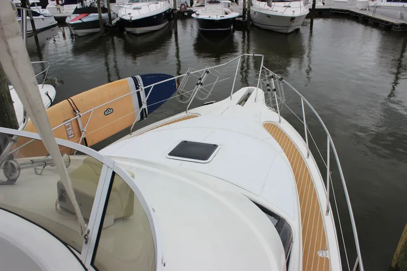 Slide: The Image of 1997 Silverton 351 Sedan yacht docked, featuring a spacious deck and sleek design. - 42