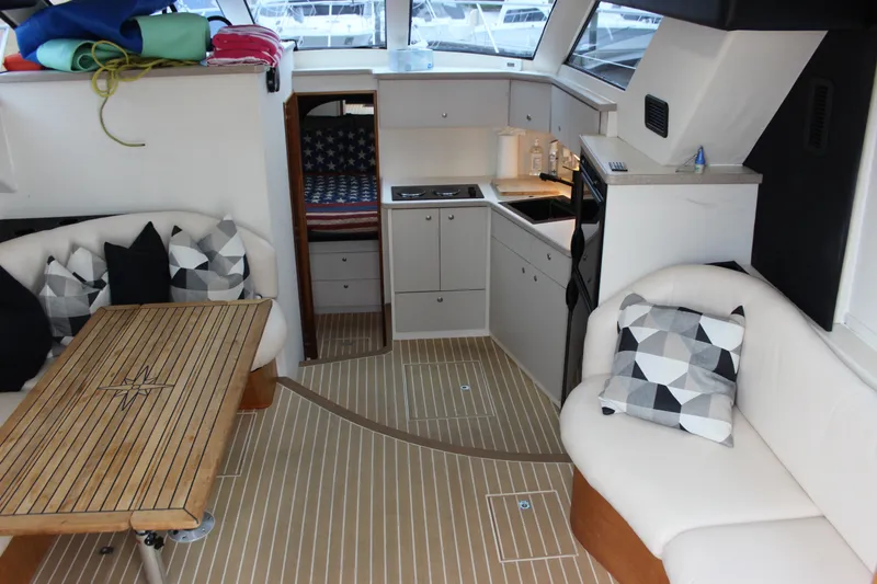 Slide: The Image of Interior of a 1997 Silverton 351 Sedan yacht with cozy seating and modern kitchen. - 26