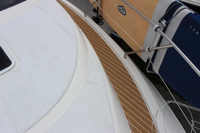 Slide: The Image of 1997 Silverton 351 Sedan yacht deck with wood accents and railing. - 50