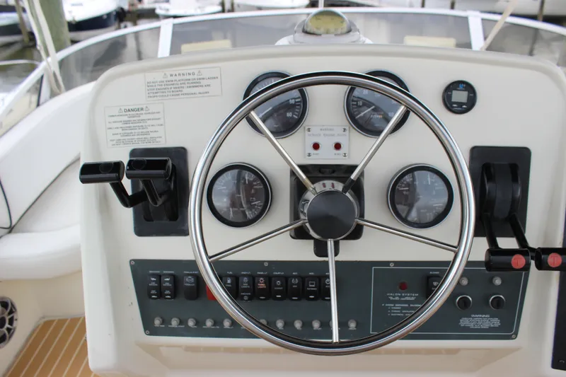 Slide: The Image of 1997 Silverton 351 Sedan helm with steering wheel and control panel. - 19