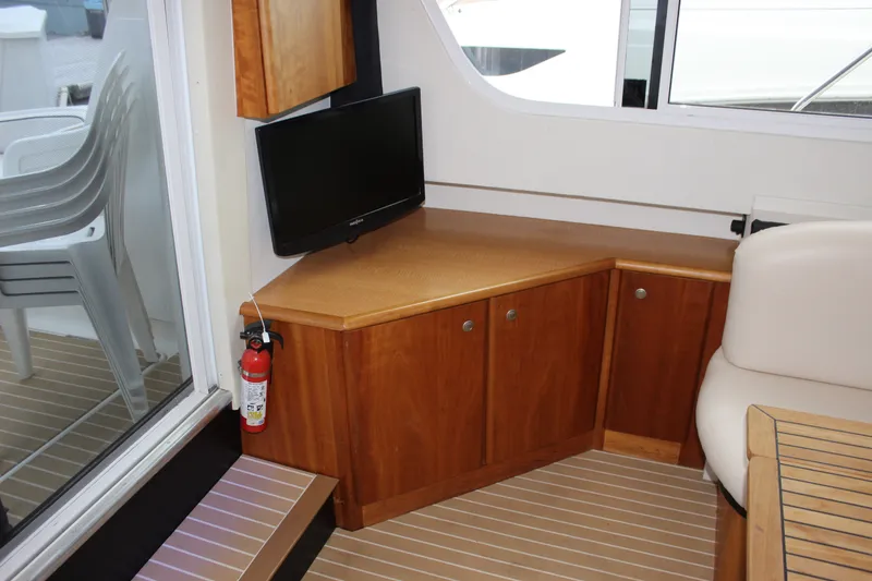 Slide: The Image of Interior of a 1997 Silverton 351 Sedan with wooden cabinets and a mounted TV. - 27
