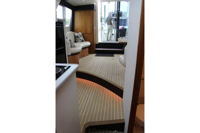 Slide: The Image of Interior of a 1997 Silverton 351 Sedan with sleek wood flooring and modern furnishings. - 46