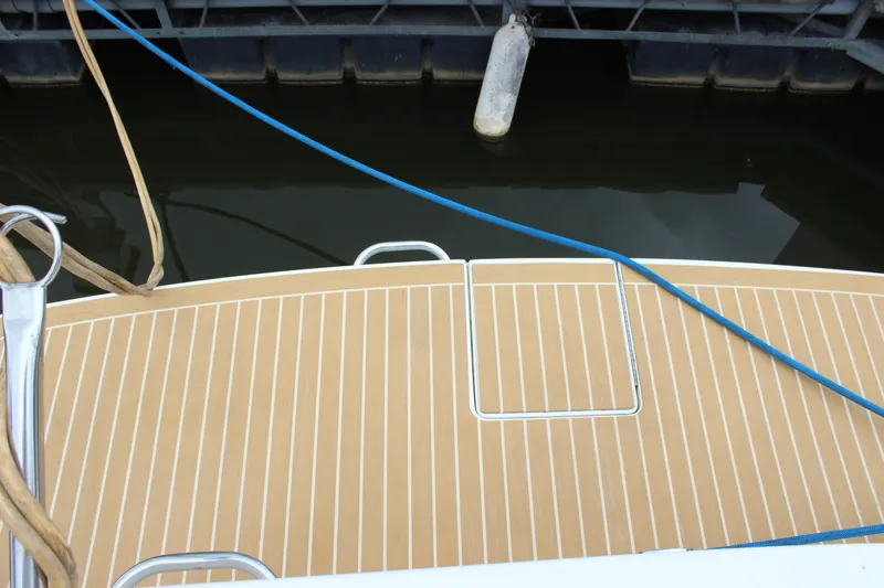 Slide: The Image of 1997 Silverton 351 Sedan boat deck with ropes and dock fender. - 23