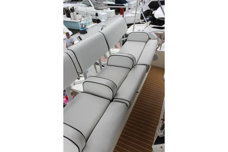 Slide: The Image of 1997 Silverton 351 Sedan boat seating area with white cushioned seats and black trim. - 16